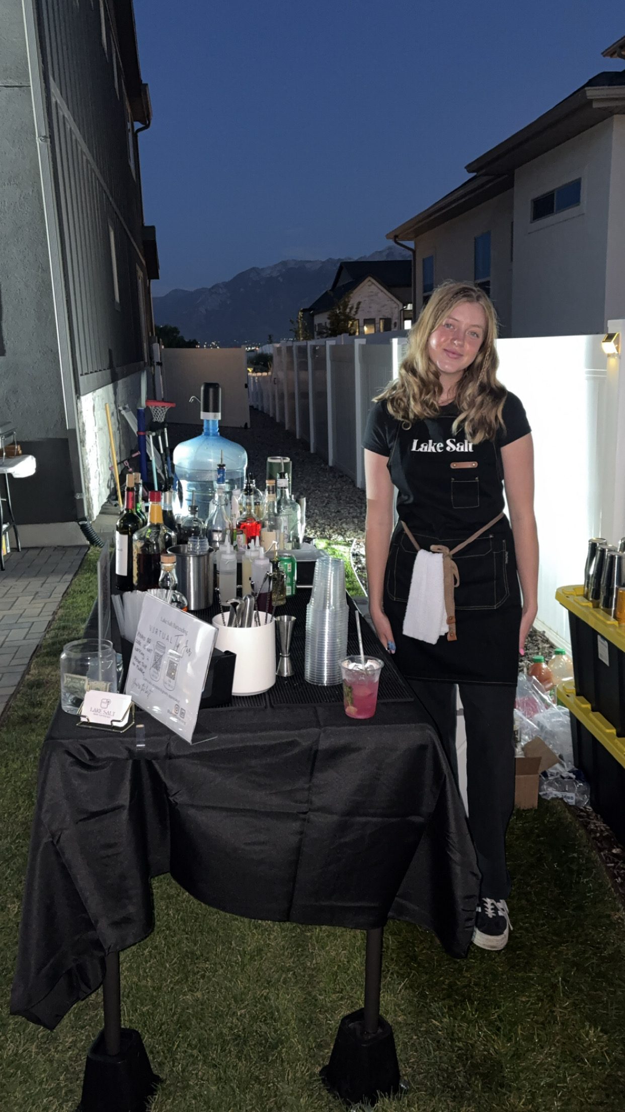 Lake Salt bartender at outdoor bar with Utah mountains at dusk