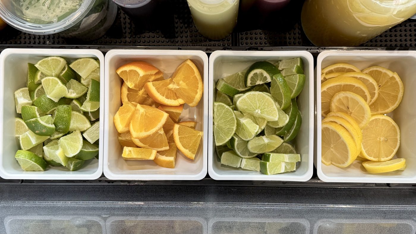 Fresh citrus garnish station — limes, oranges, lemons
